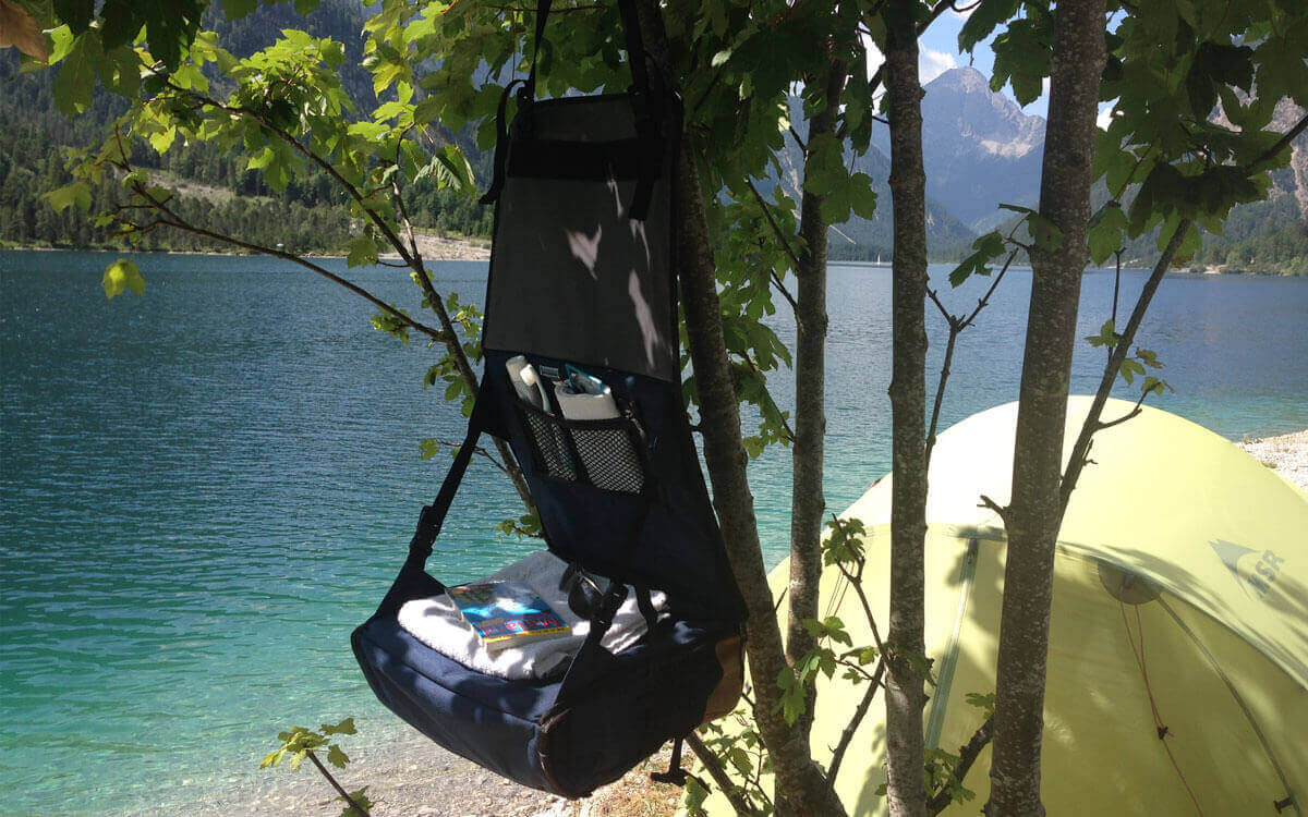 Camping on a lake with hanging toiletry bag
